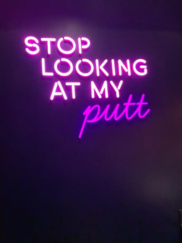 "Stop looking at my Putt" sign at Puttshack in Oakbrook Chicago