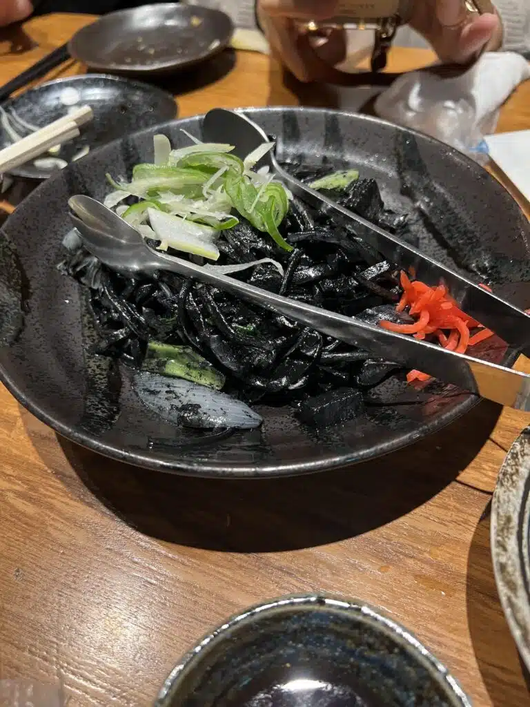 Squid ink noodles on a food tour in Tokyo, Japan