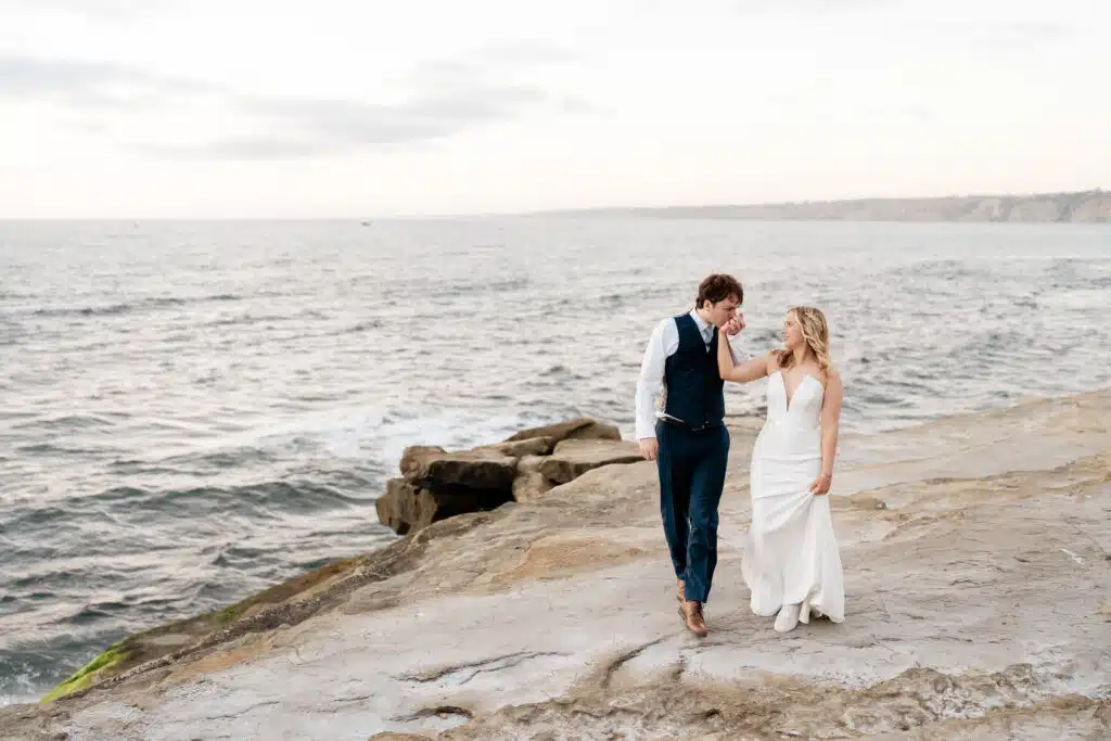 Walking on the beach in La Jolla after our wedding ceremony. We chose our vendors carefully to help travel hack our honeymoon. 