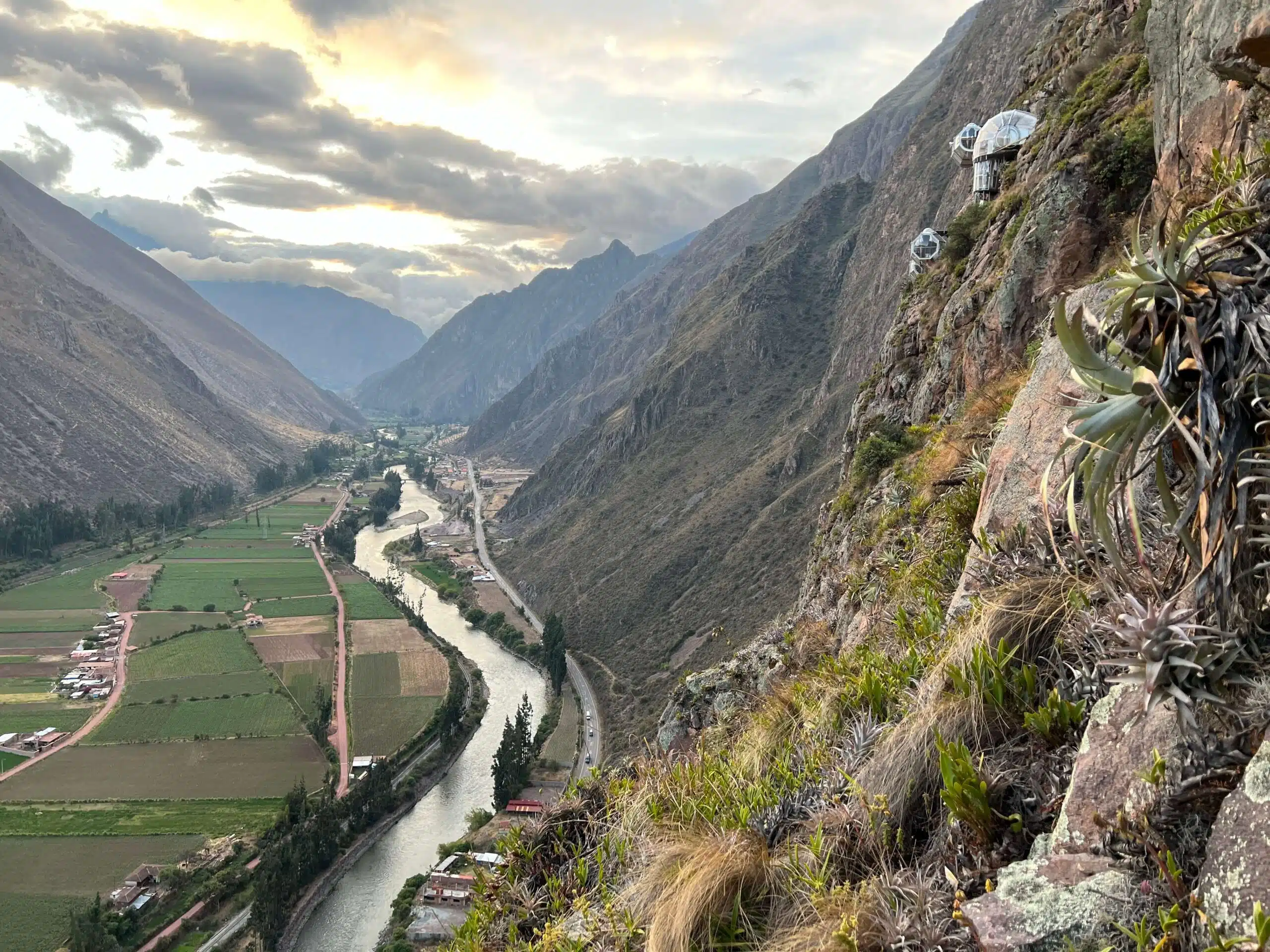 A view of the Skylodge Adventure Suites and the Peruvian Sacred Valley below