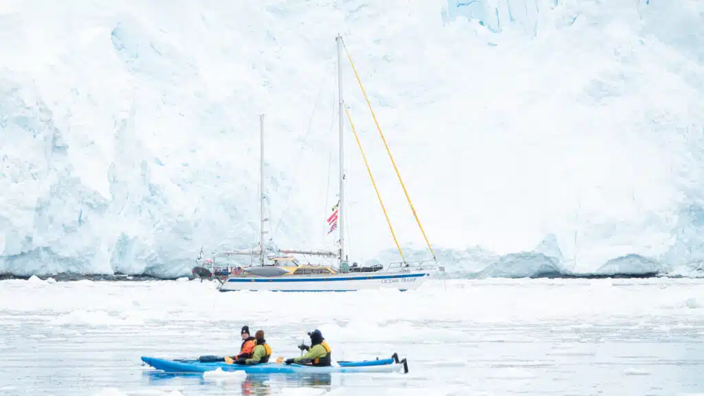 Kayaks and a sailboat in Antarctica