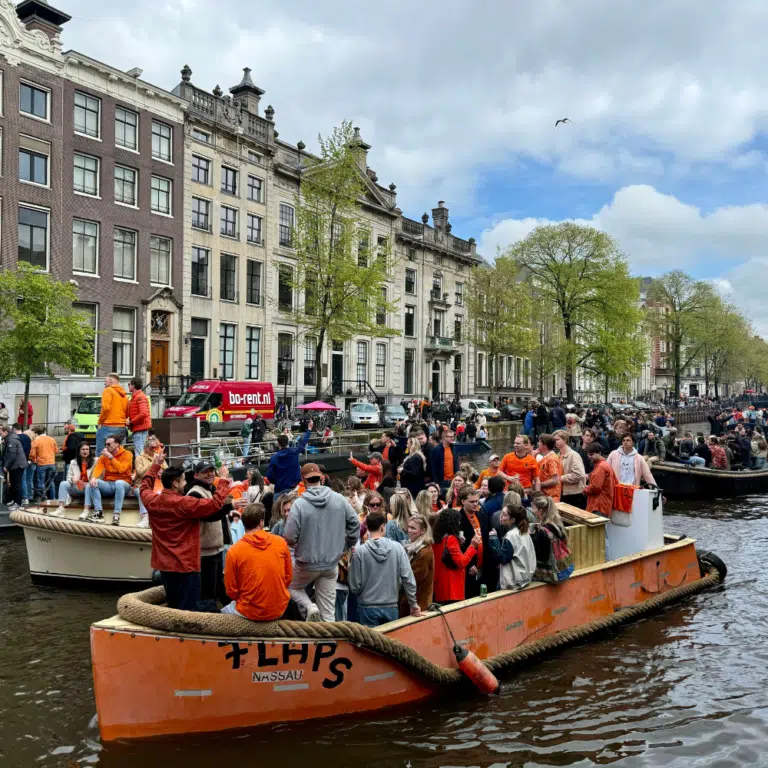 Party boats on the canals on Amsterdam on King's Day