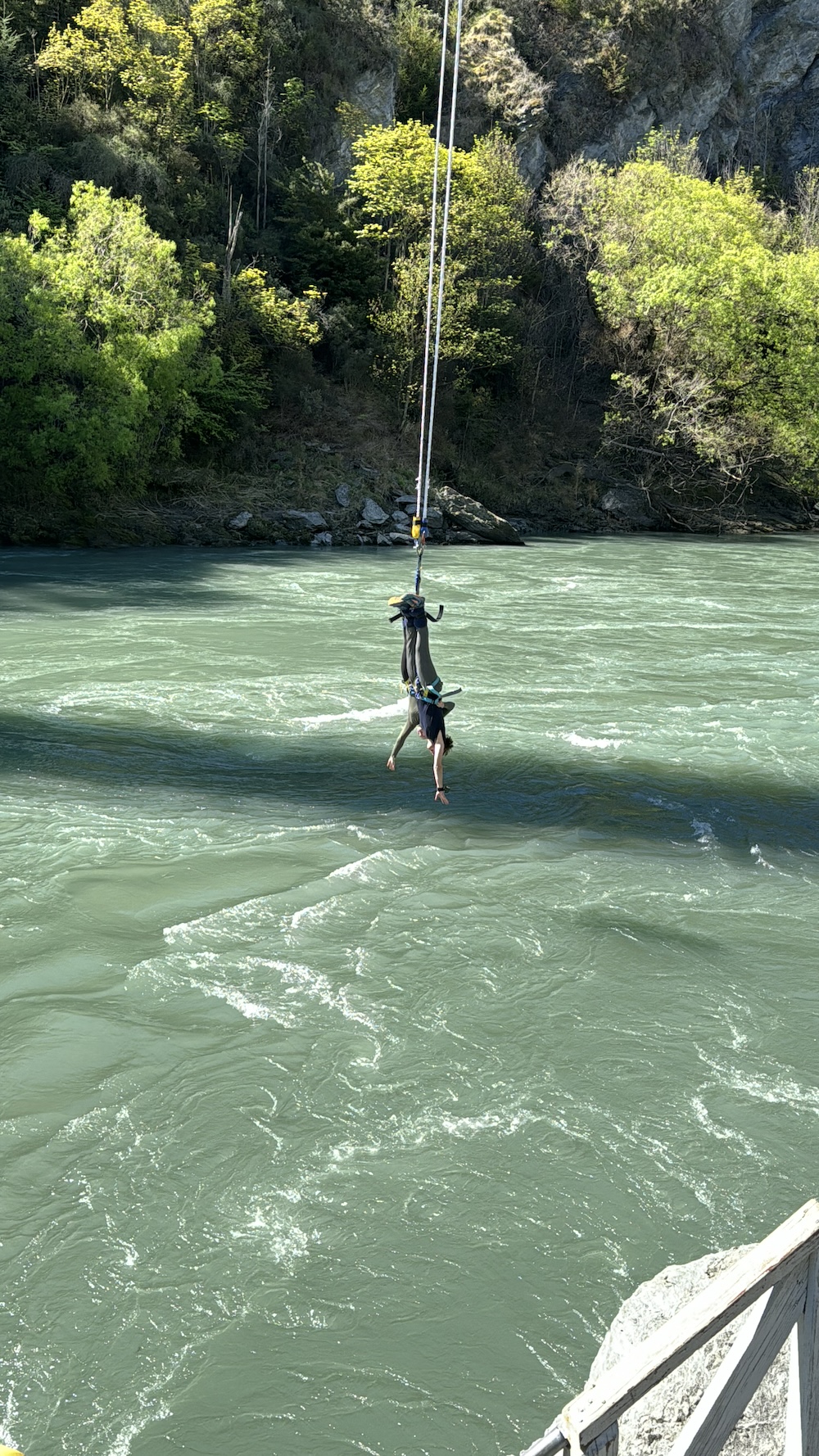 the author and her husband tandem bungee jumping and almost touching the water