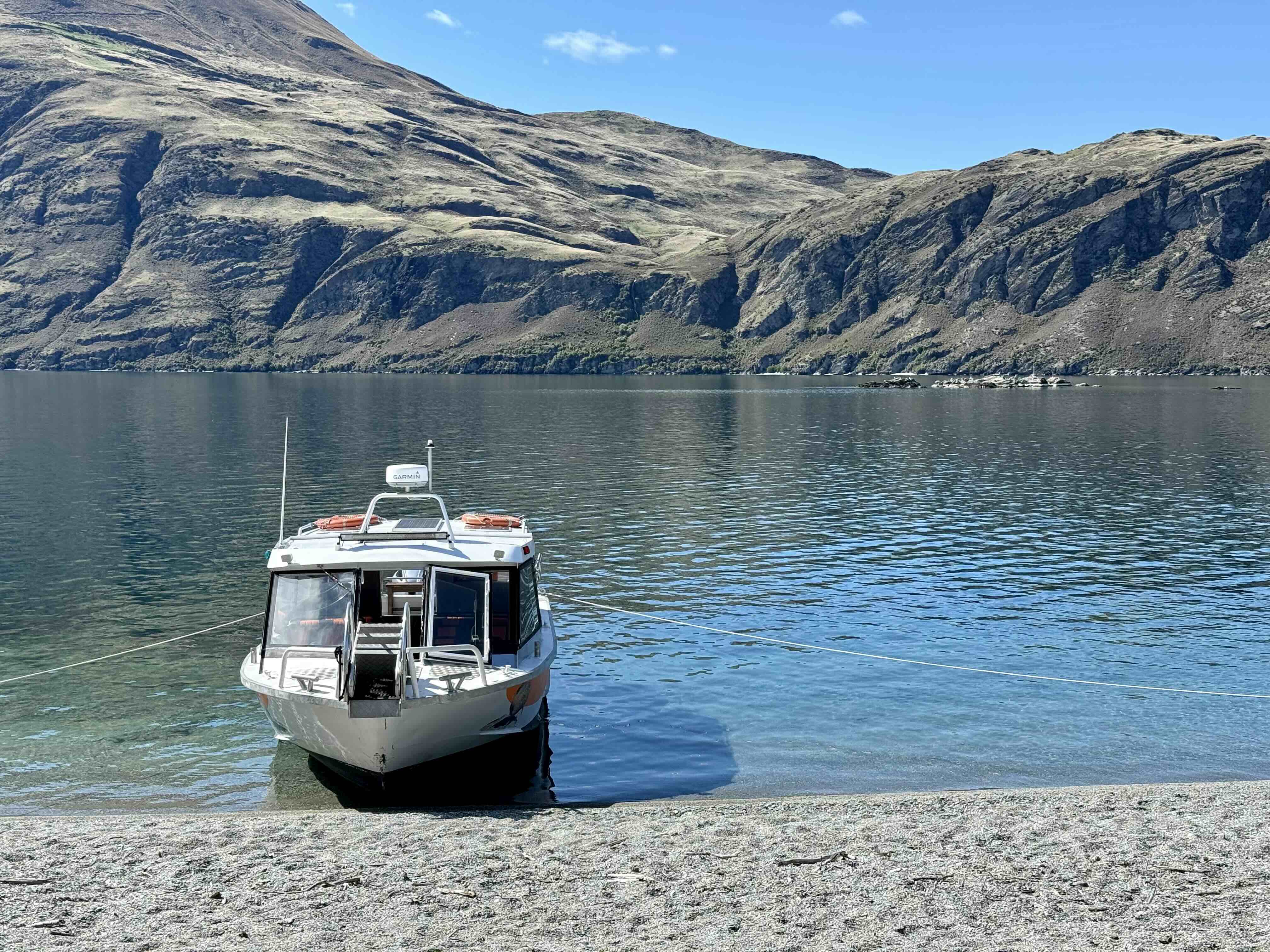 Lake Wanaka Cruises boat moored on Mou Waho Island